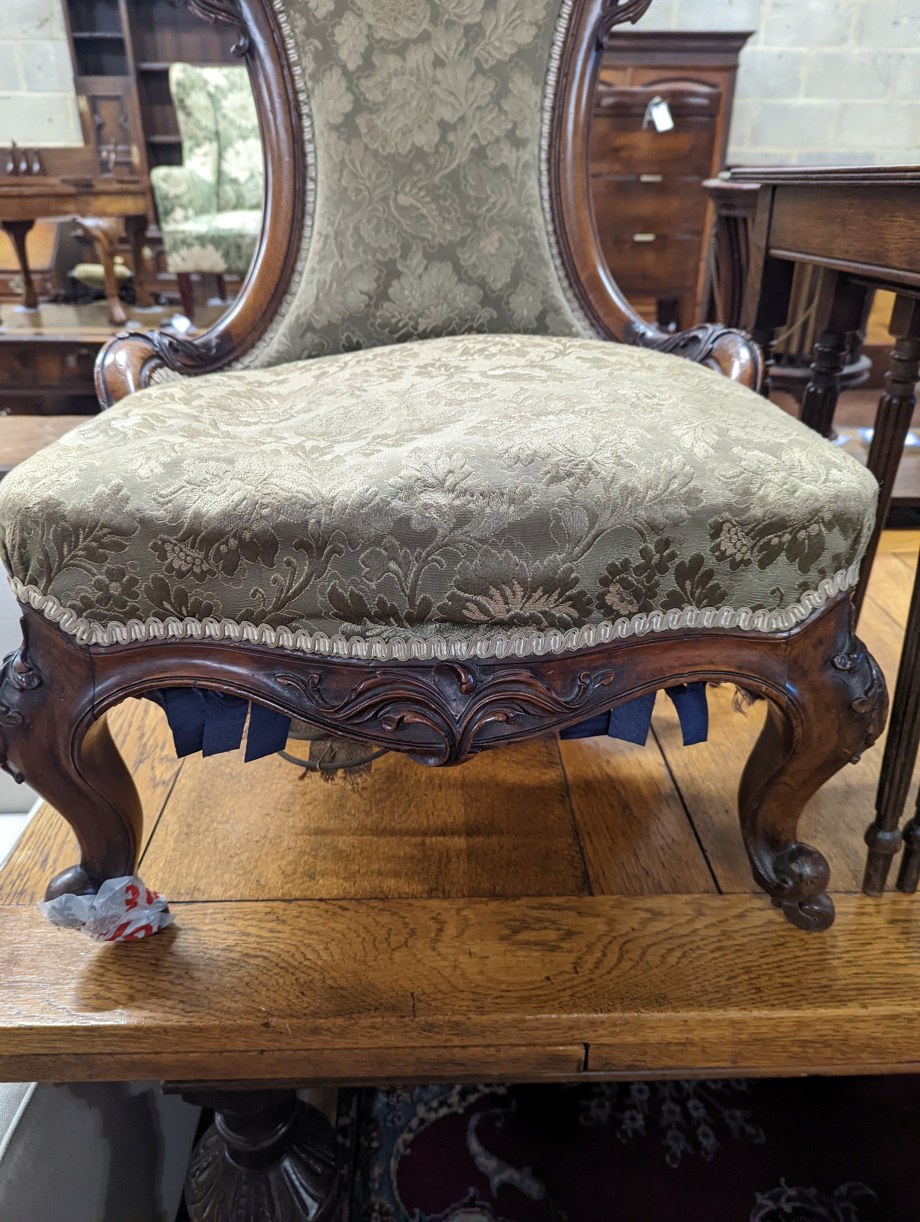 A Victorian walnut nursing chair together with a reproduction nest of tea tables